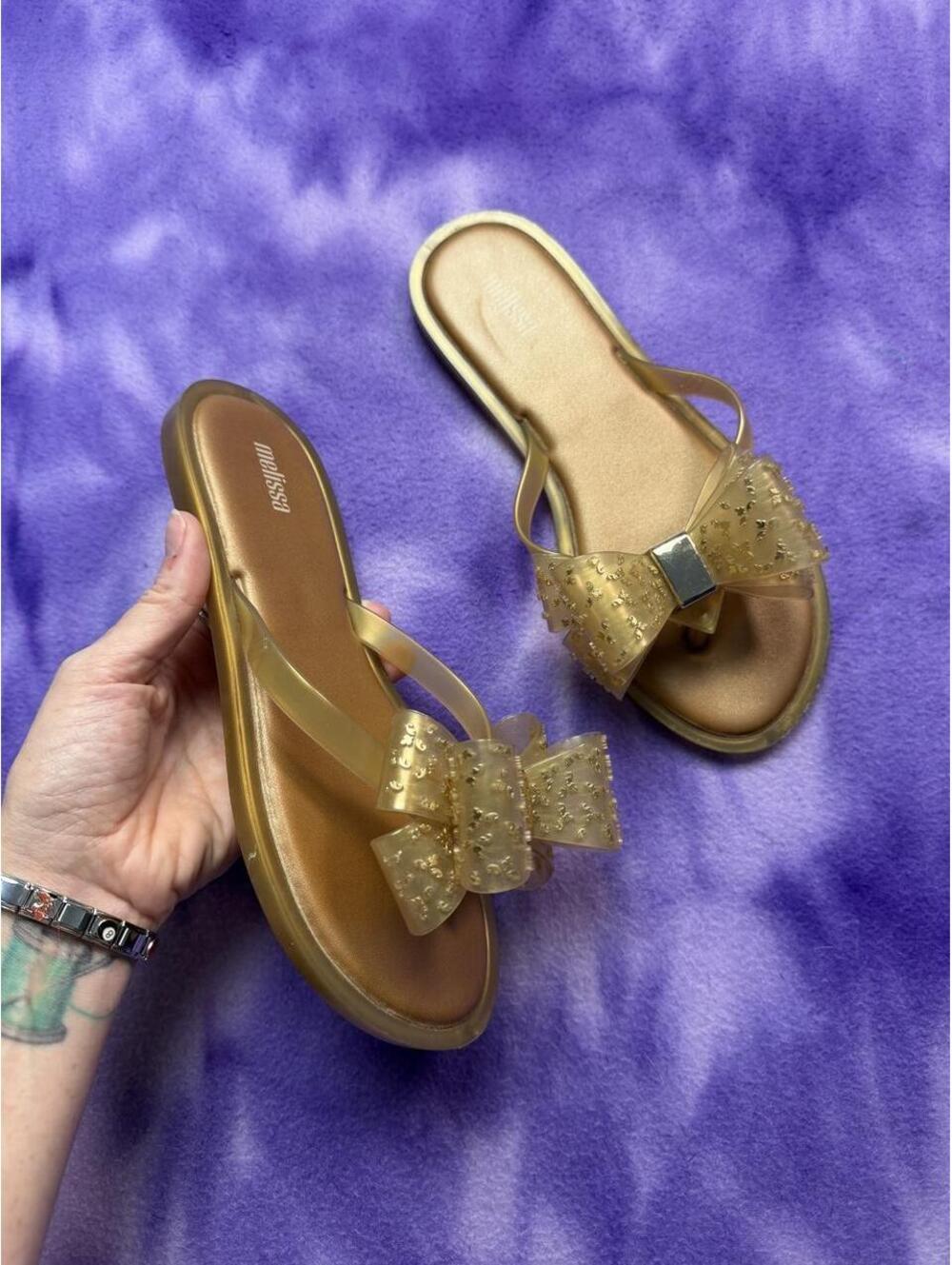 Melissa gold jelly flip flops with bow detail